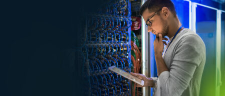 A worker in a tech lab pondering a decision