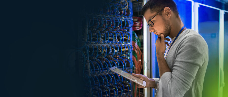 A worker in a tech lab pondering a decision